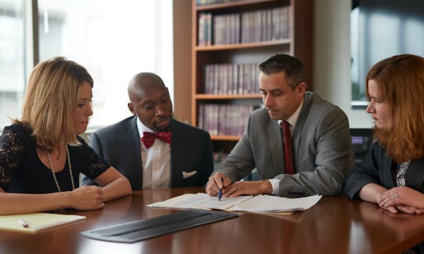 Attorneys at Flexer Law sit around a table while discussing a bankruptcy case in Nashville, TN.